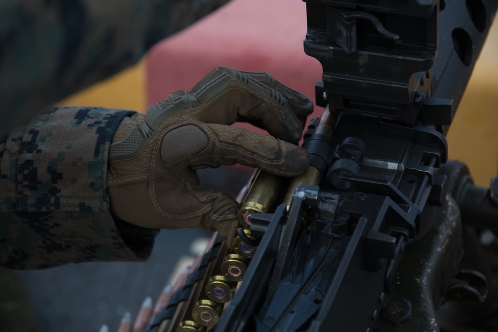 Weapons Company Marines fire machine guns aboard the Wasp