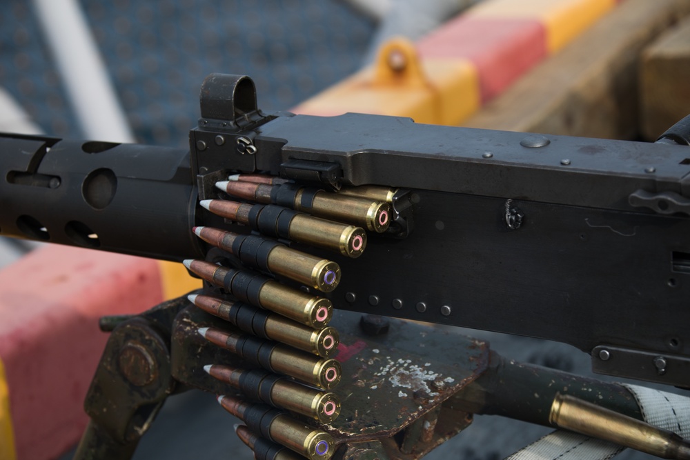 Weapons Company Marines fire machine guns aboard the Wasp