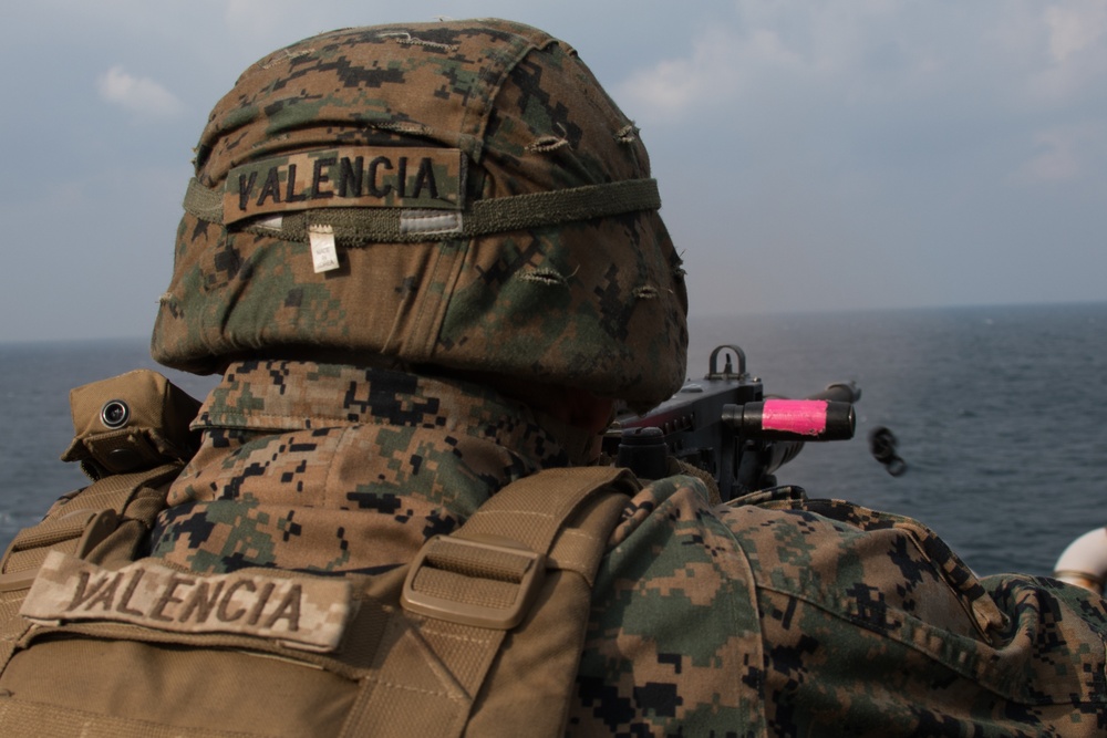 Weapons Company Marines fire machine guns aboard the Wasp