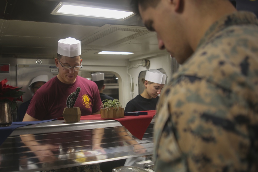 Food Service Marines aboard the USS Wasp serve food