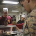 Food Service Marines aboard the USS Wasp serve food