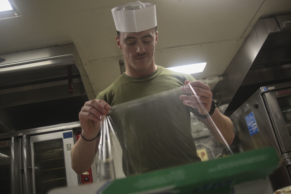 Food Service Marines aboard the USS Wasp serve food