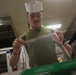 Food Service Marines aboard the USS Wasp serve food