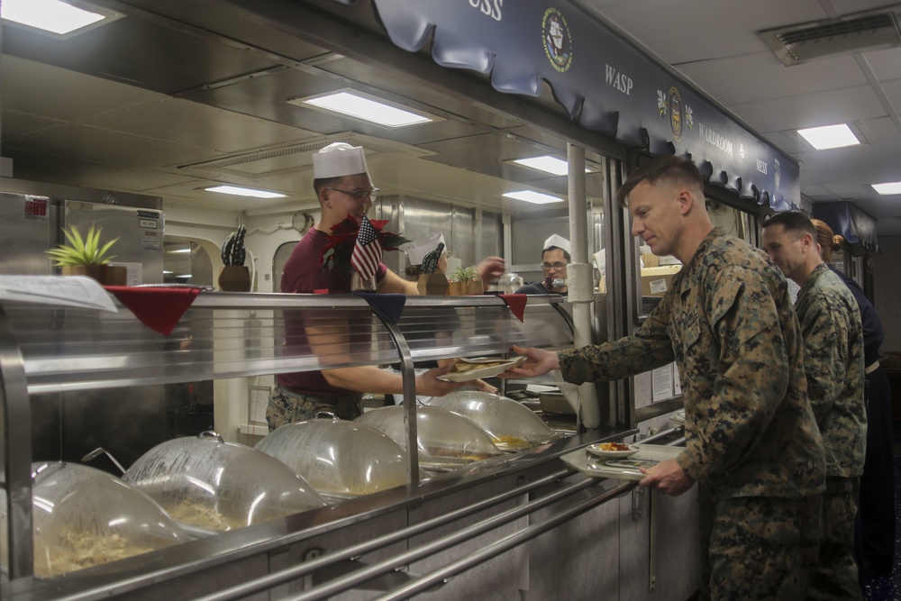 Food Service Marines aboard the USS Wasp serve food