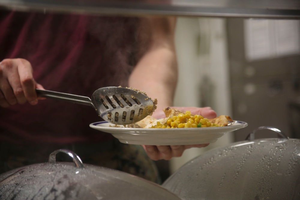 Food Service Marines aboard the USS Wasp serve food