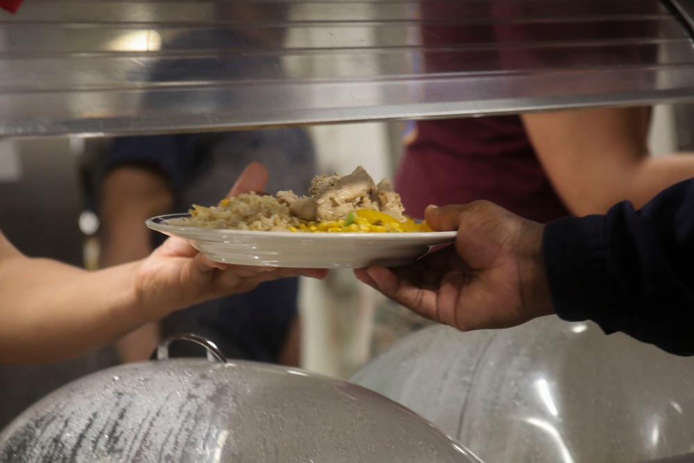 Food Service Marines aboard the USS Wasp serve food