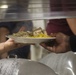 Food Service Marines aboard the USS Wasp serve food