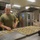 Food Service Marines aboard the USS Wasp serve food