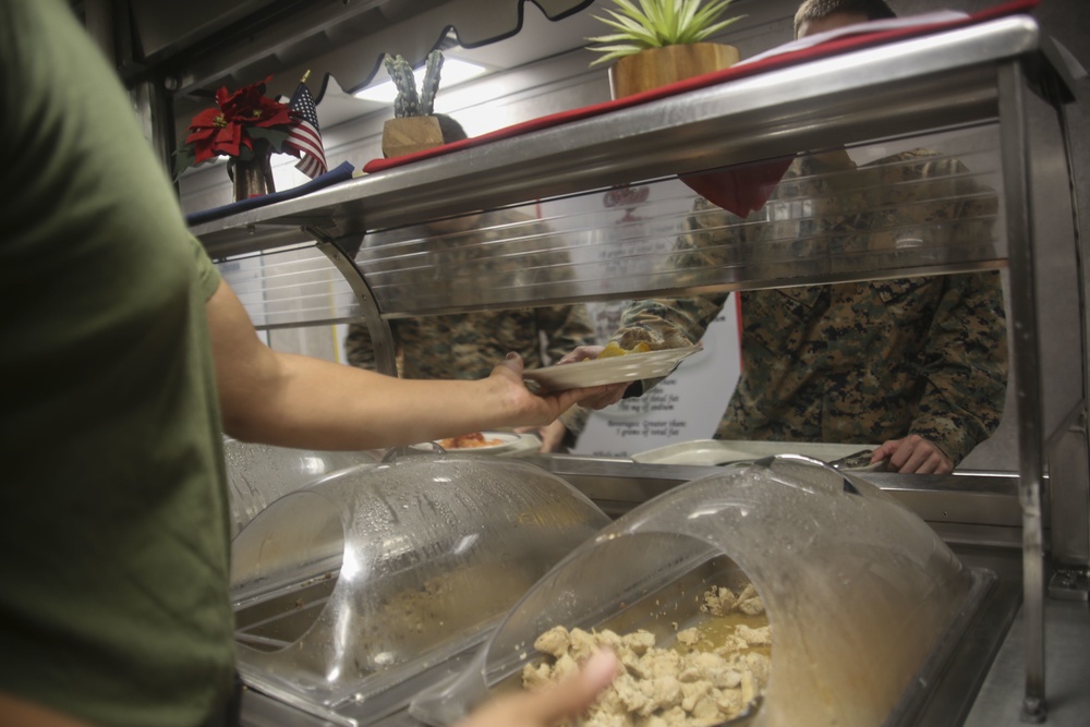 Food Service Marines aboard the USS Wasp serve food