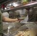 Food Service Marines aboard the USS Wasp serve food