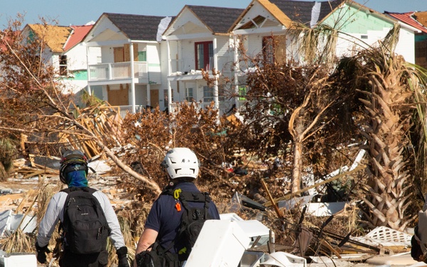 Urban search and rescue crews sitfs through debris of what used to be homes and businesses in Mexico Beach