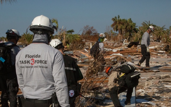 Urban search and rescue crews sitfs through debris of what used to be homes and businesses in Mexico Beach