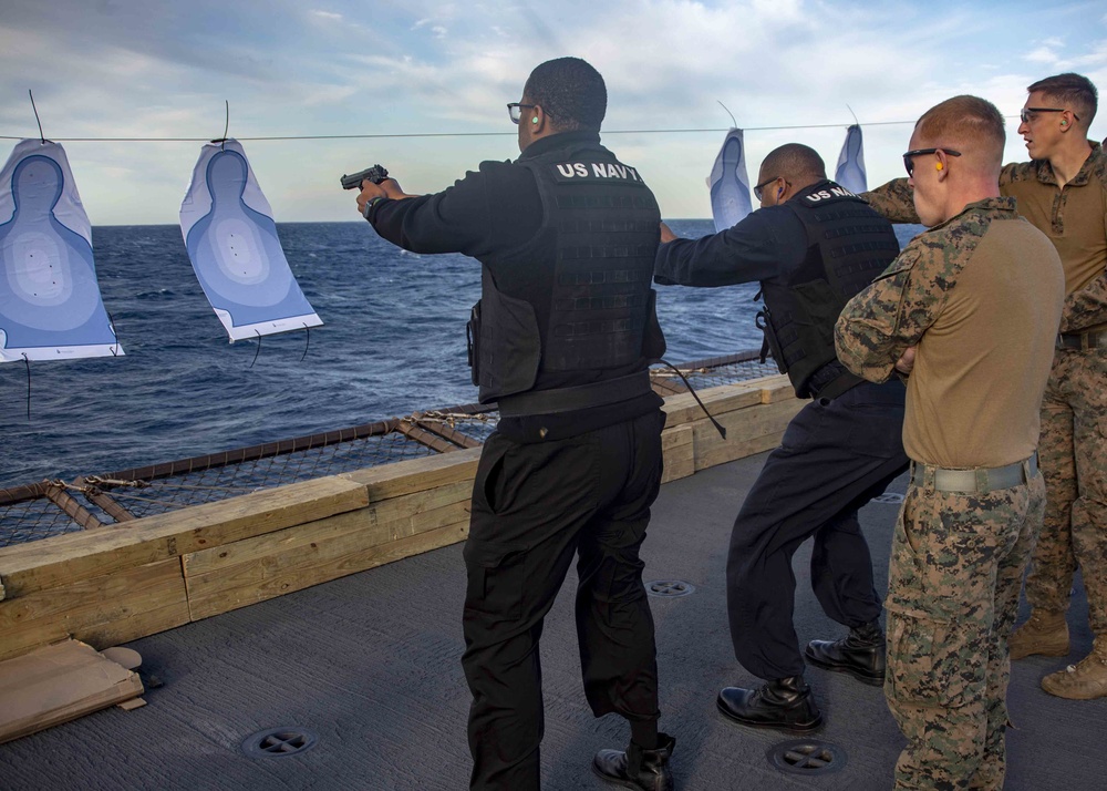 Marines Coach Sailors on pistol marksmanship and machine gunnery