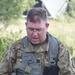 U.S. Army Chaplain (Capt.) Kyle Wiberg, 125th Chaplain Detachment, reads scripture to a group of Soldiers