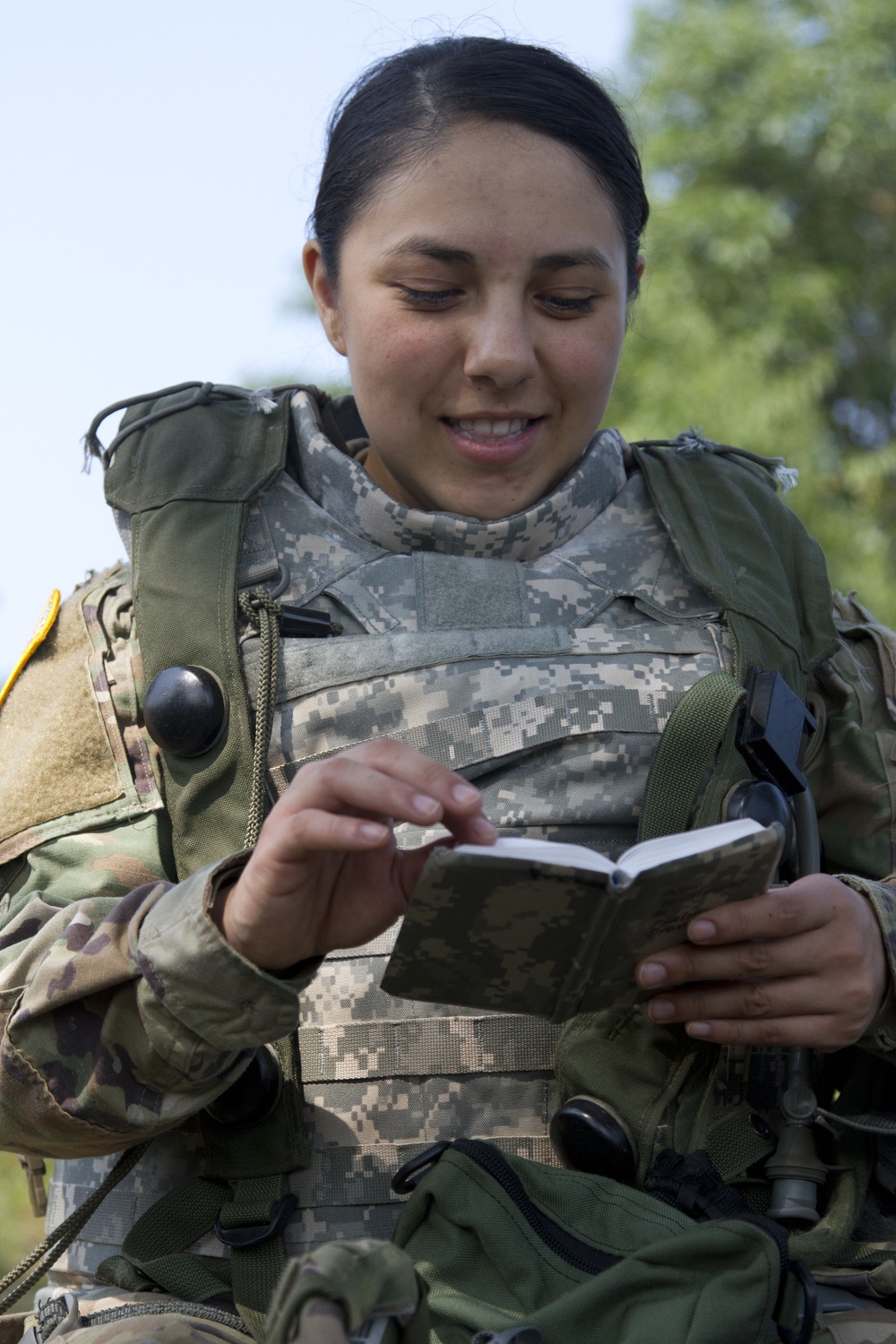 U.S. Army Spc. Mariah Garza, 422nd Military Police Company, reads the bible during a religious service at Fort McCoy