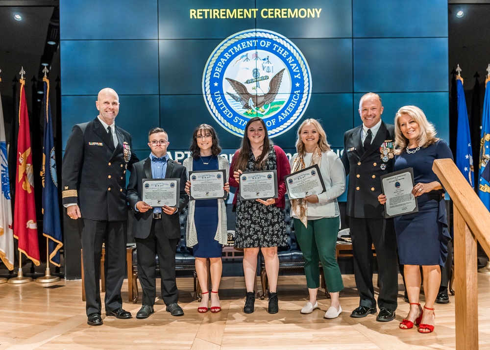 Navy Capt. Brian Ginnane’s wife and children were presented with certificates
