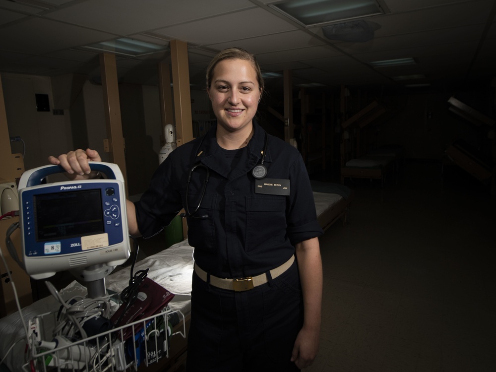 Ens. Maggie Berky Poses Next to Her Equipment Aboard the USNS Comfort