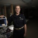 Ens. Maggie Berky Poses Next to Her Equipment Aboard the USNS Comfort