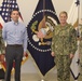 DLA Aviation’s Industrial Support Activity leaders pose in front of the presidential flag in the DLA Troop Support Flag Room in Philadelphia Oct. 18, 2018.