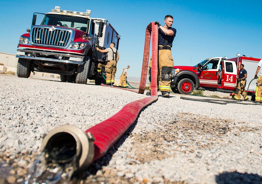 99th CES, local fire department battle simulated aircraft fire