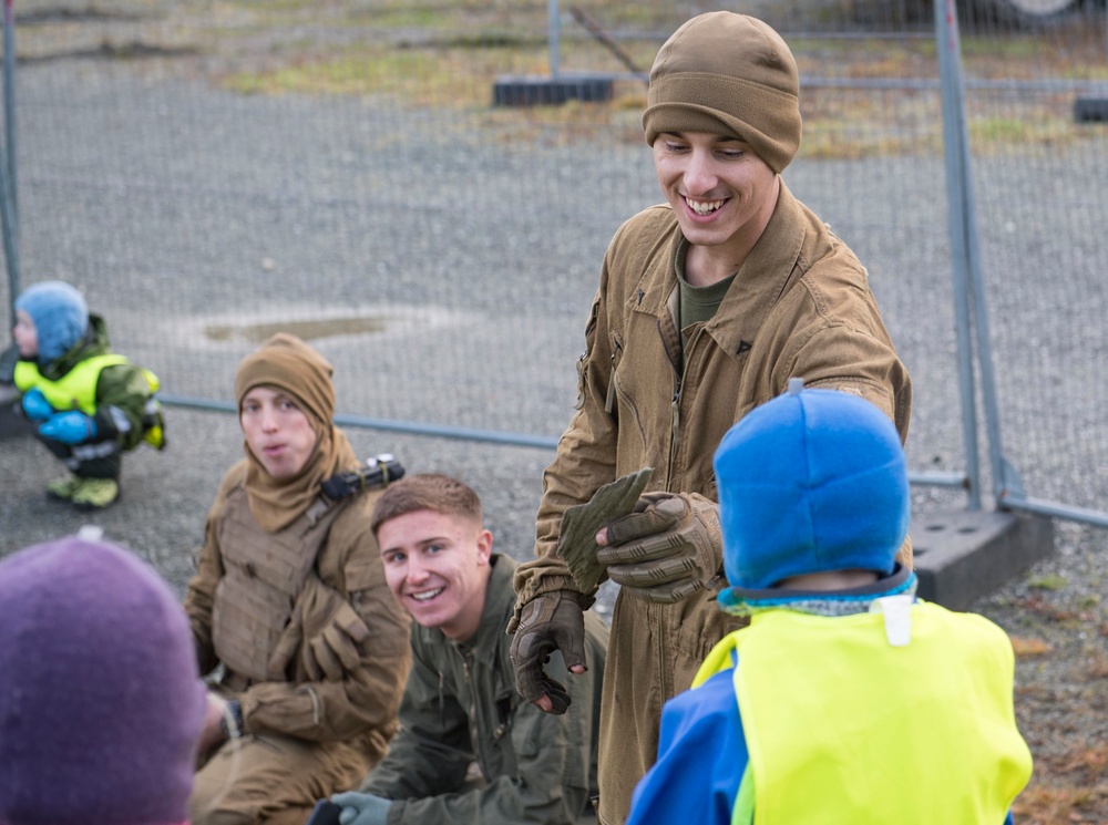 U.S. Marines interact with Norwegian children during Trident Juncture 18