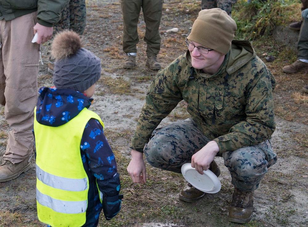 U.S. Marines interact with Norwegian children during Trident Juncture 18