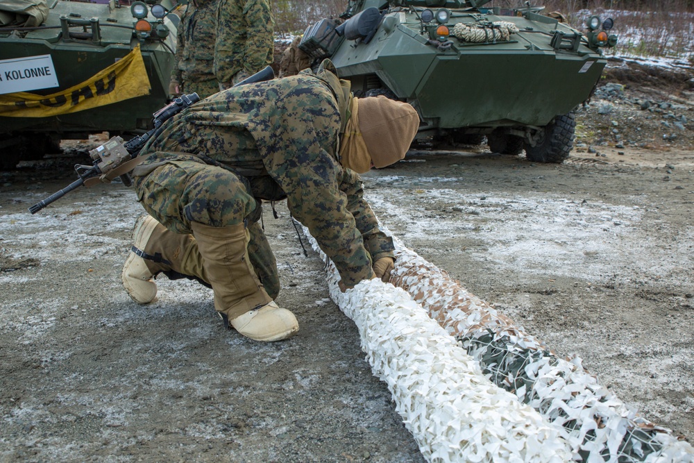 Marines with 2nd Light Armored Reconnaissance prepare snow camouflage