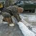 Marines with 2nd Light Armored Reconnaissance prepare snow camouflage