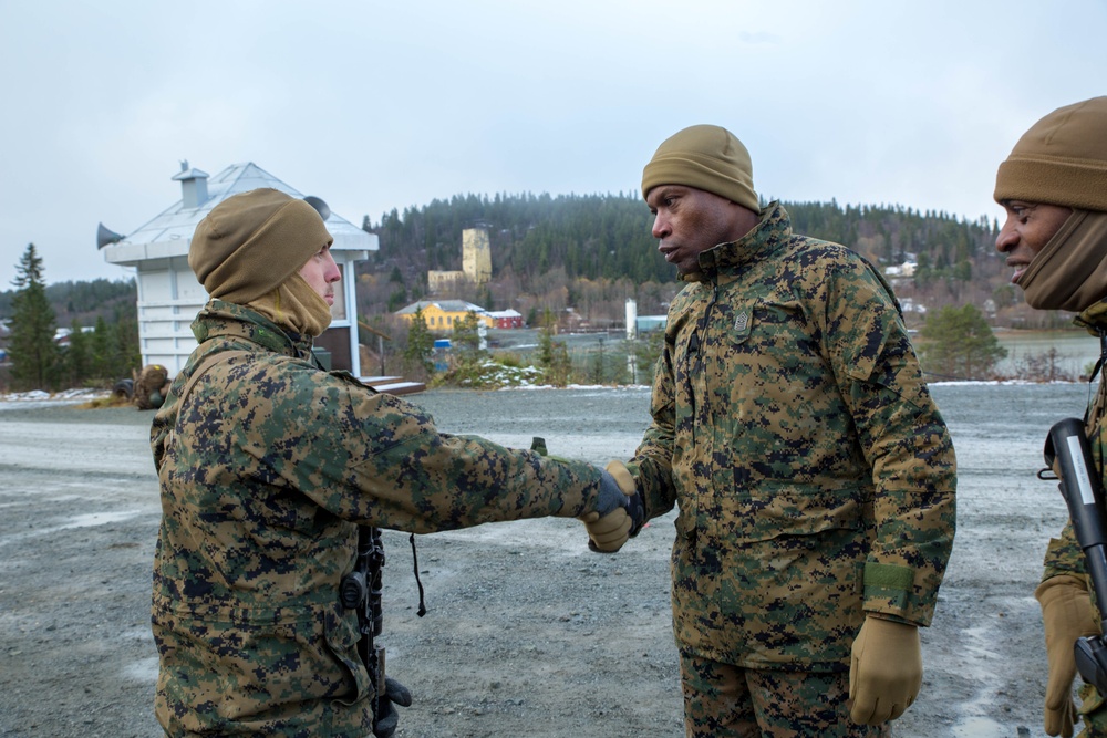 Marines with 2nd Light Armored Reconnaissance prepare snow camouflage