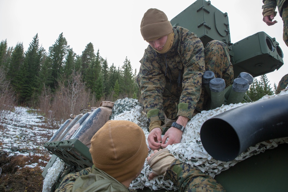 Marines with 2nd Light Armored Reconnaissance prepare snow camouflage