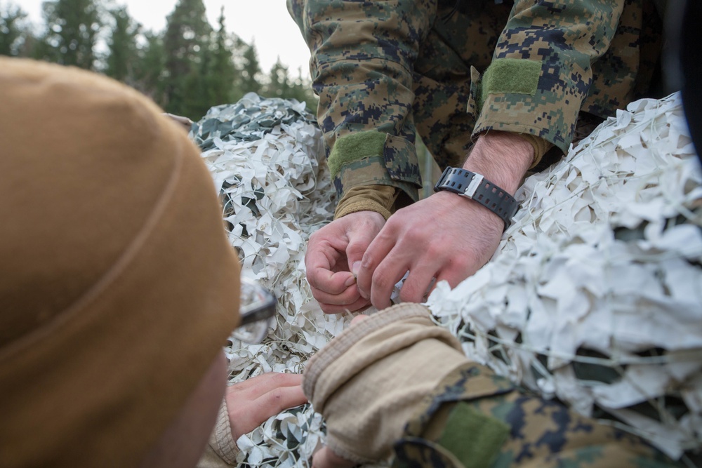 Marines with 2nd Light Armored Reconnaissance prepare snow camouflage