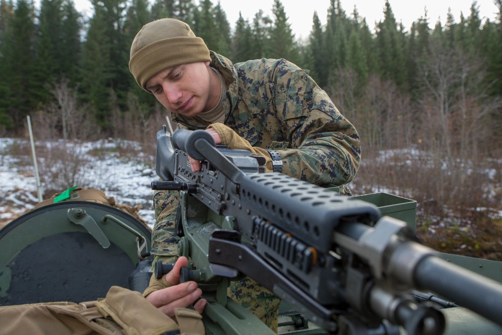 Marines with 2nd Light Armored Reconnaissance prepare snow camouflage