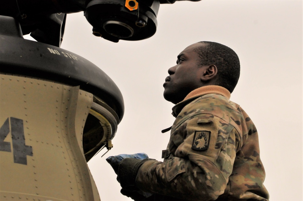 Soldier conducting maintenance on an CH-47 Chinook helicopter.