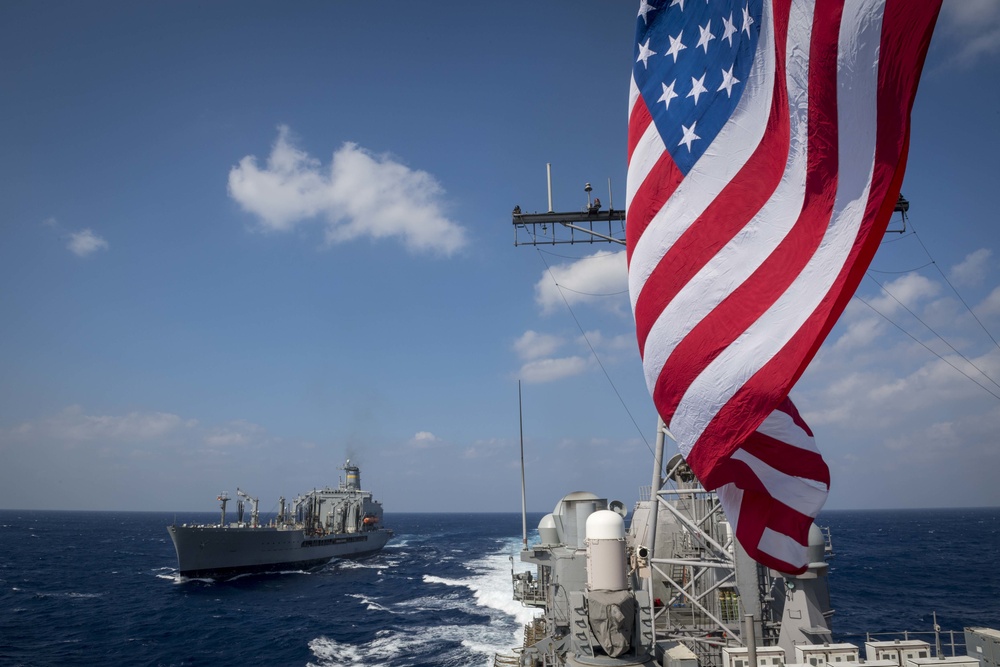 The Ticonderoga-class guided-missile cruiser USS Chancellorsville (CG 62) finishes a replenishment-at-sea with the Military Sealift Command fleet replenishment oiler USNS Tippecanoe (T-AO 199)