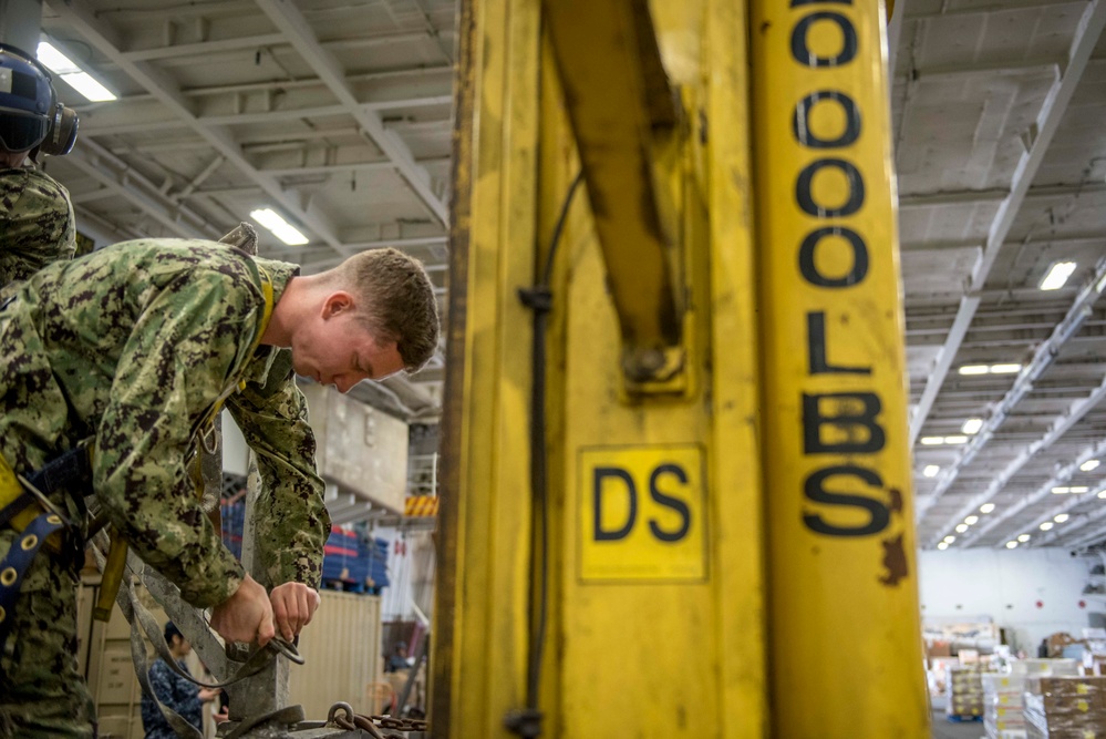 Sailors repair ship's christening seal