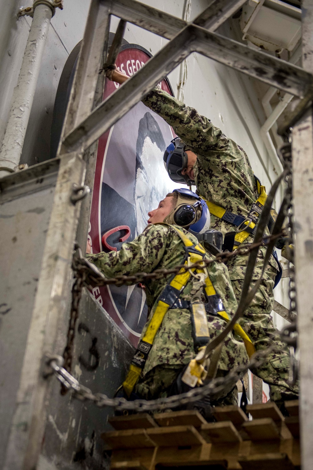 Sailors repair ship's christening seal