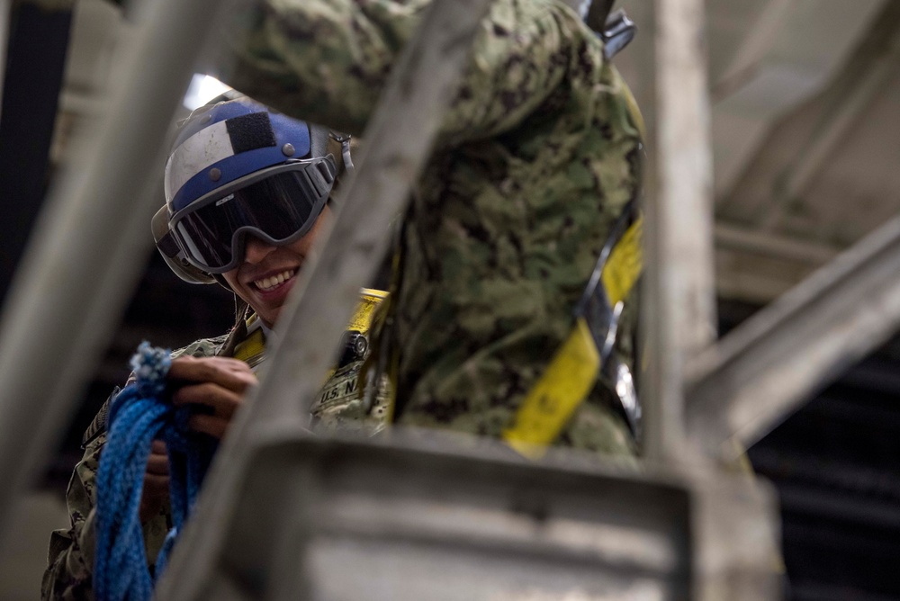 Sailors repair ship's christening seal