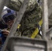 Sailors repair ship's christening seal