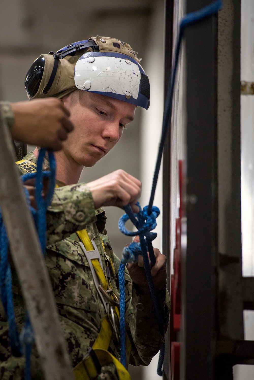 Sailors repair ship's christening seal