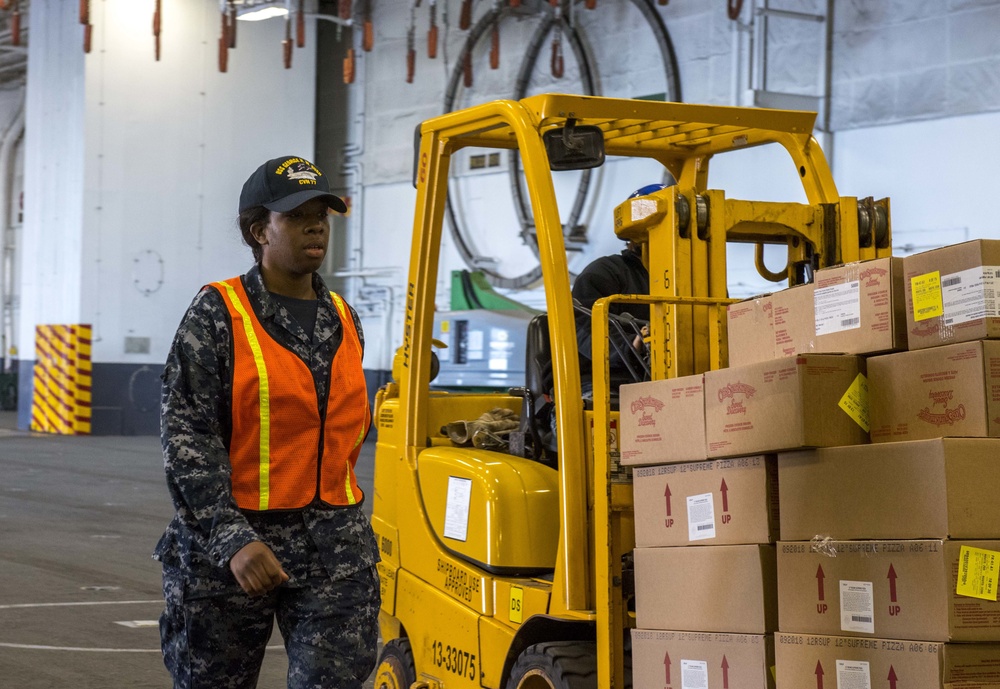 Sailor Escorts Forklift With Supplies