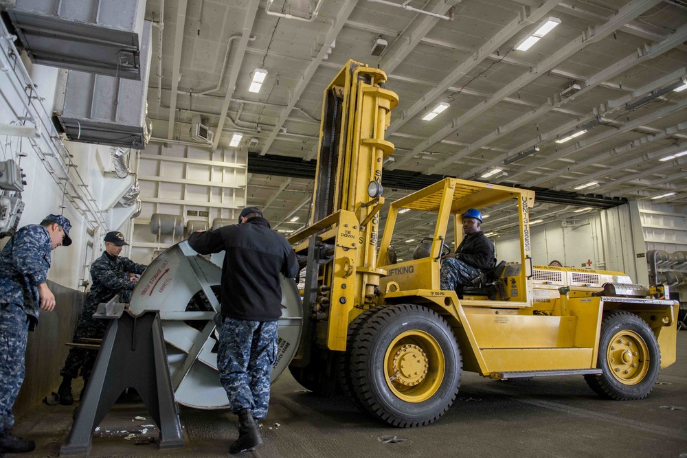 Sailors Move Arresting Gear Wire Spool