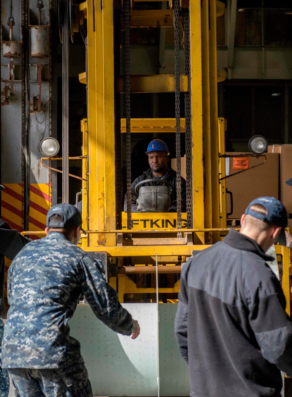 Sailor Operates Forklift