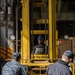 Sailor Operates Forklift