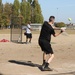 U.S. and Canadian service members play a friendly game of softball