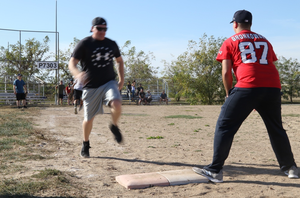 U.S. and Canadian service members play a friendly game of softball