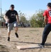 U.S. and Canadian service members play a friendly game of softball