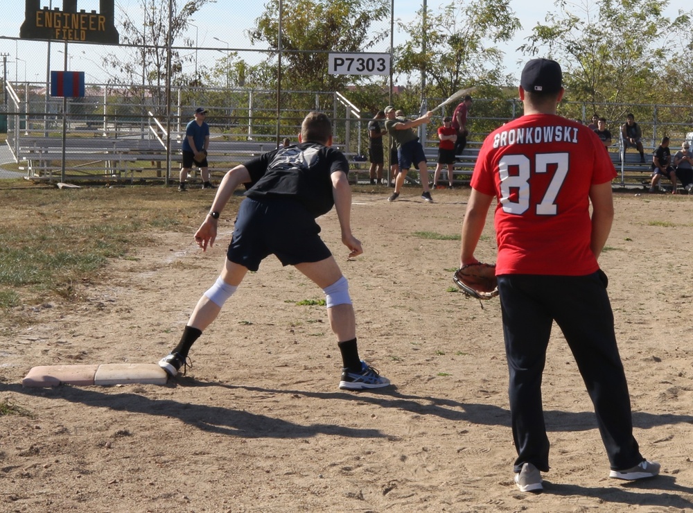 U.S. and Canadian service members play a friendly game of softball