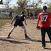 U.S. and Canadian service members play a friendly game of softball