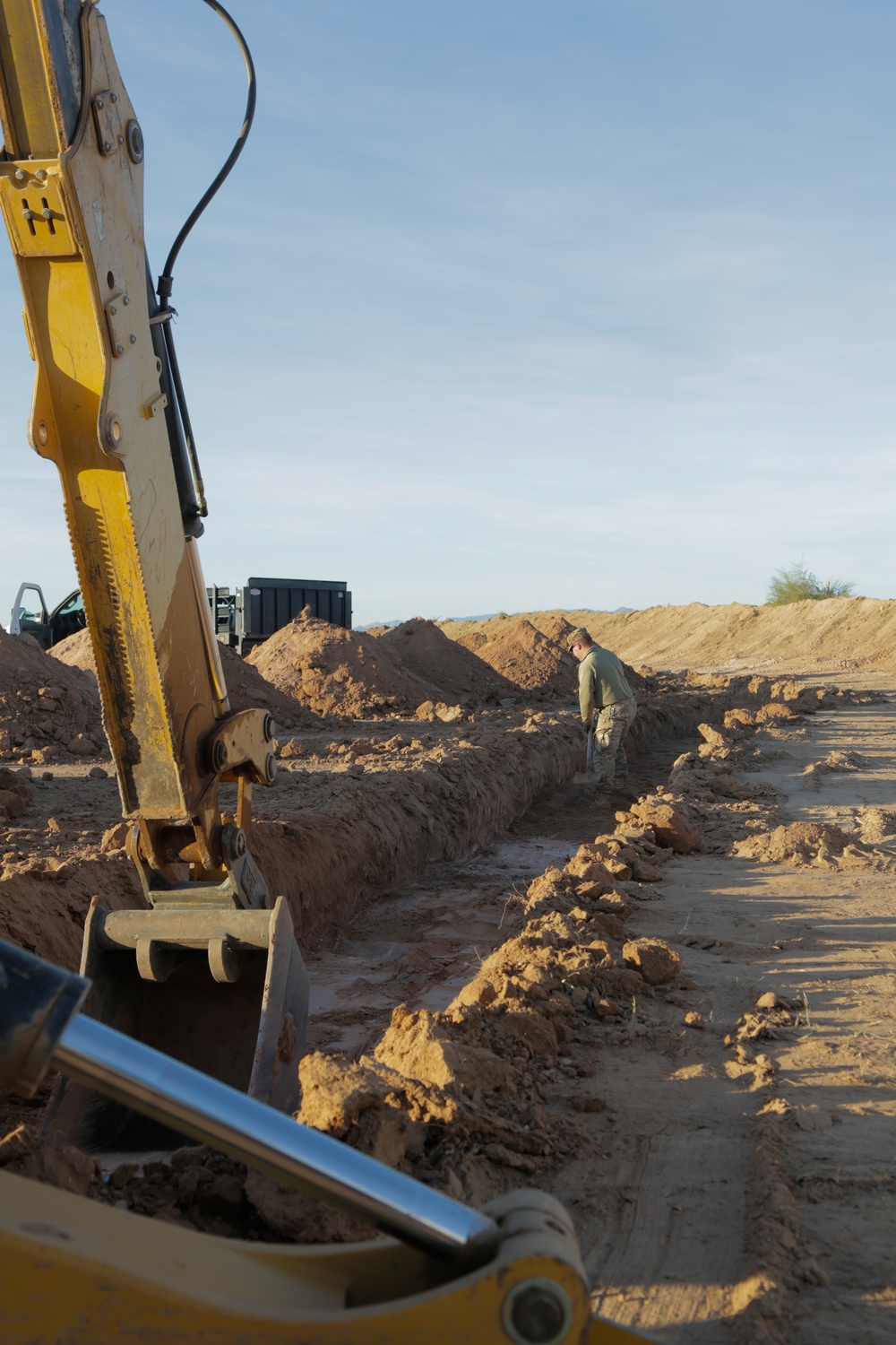 Soldier digs trench to improve security efforts