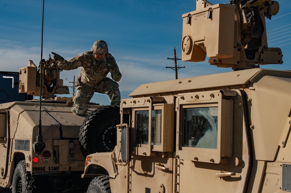 93rd Military Police Battalion Soldier Guides a HMMWV